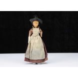 A 19th century English wax over papier-mâché doll in Welsh traditional costume,