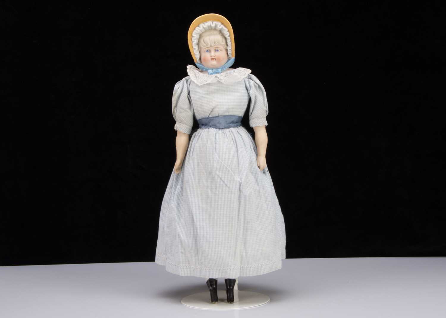 An unusual German bisque shoulder-head doll would moulded bonnet,