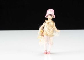 A Hertwig all-bisque long-legged dolls’ house doll in moulded hat,