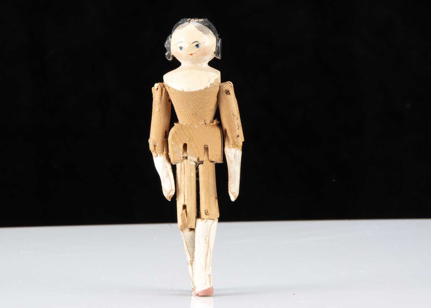 A small 19th century Grodnerthal doll with side ringlets,