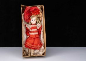 A German 457 bisque head doll in factory dress and box base,