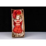 A German 457 bisque head doll in factory dress and box base,