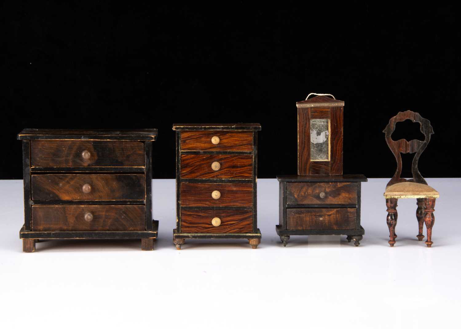 Five pieces of German 19th century wood grained dolls’ house furniture,