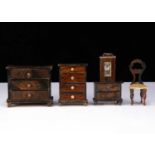 Five pieces of German 19th century wood grained dolls’ house furniture,