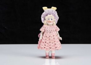 A Hertwig all-bisque dolls’ house doll with moulded bonnet,