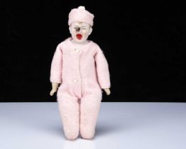 An unusual pink bisque shoulder-head baby doll with fly on face,