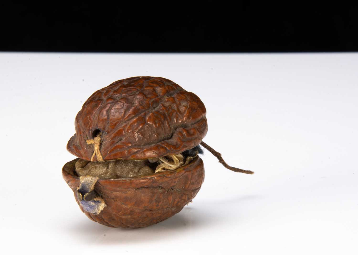 A rare 19th century china Frozen Charlotte in a walnut shell, - Image 2 of 2