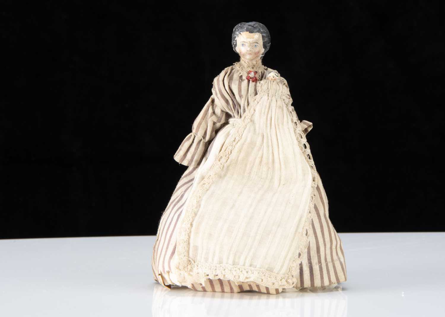 A 19th century composition ‘alien’ headed dolls’ house nursery maid with Grodnerthal baby,