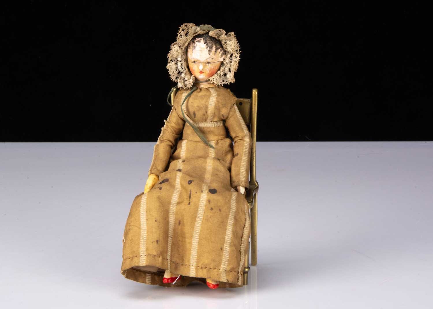 A small early 19th century Grodnerthal carved wooden doll,