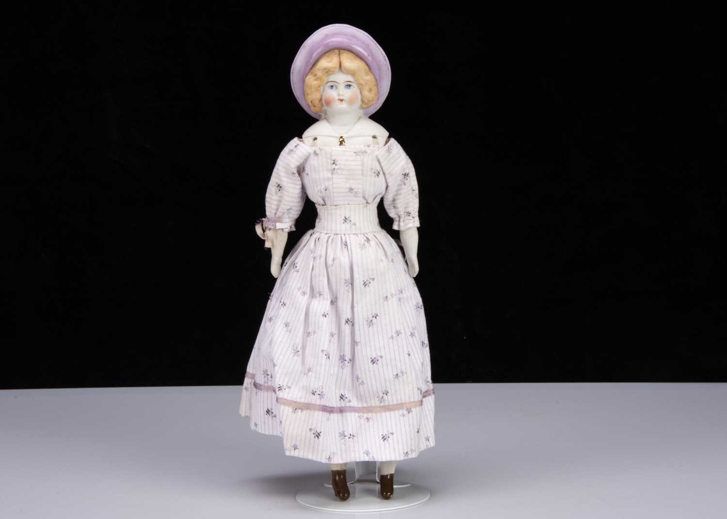 A Hertwig bisque shoulder-head doll in moulded Sou’wester hat,