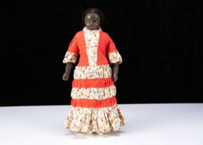 A rare 19th century English black poured wax child doll,