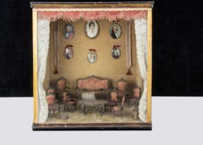 A room setting display case with ‘silver’ white metal filigree dolls’ house furniture,