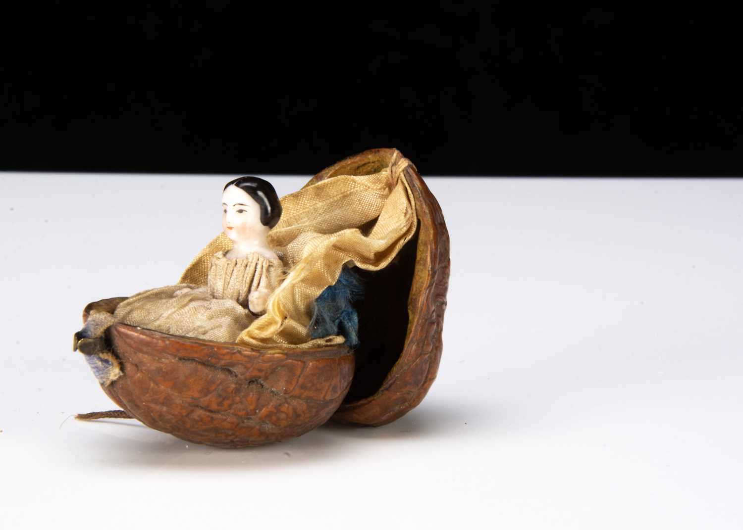 A rare 19th century china Frozen Charlotte in a walnut shell,