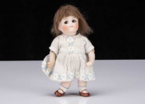 A small Kestner all-bisque 112 googly eyed girl doll,