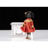 A German black swivel head dolls’ house doll,