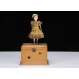 An 19th century clockwork dancing girl on musical box,