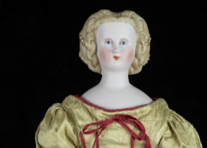A German bisque shoulder-head doll with elaborate hair,