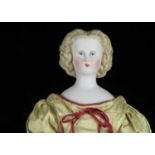 A German bisque shoulder-head doll with elaborate hair,