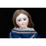 A large late 19th century French pressed bisque swivel-head fashionable doll,