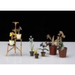 Three Viennese cold painted bronze dolls’ house flowers in pots,