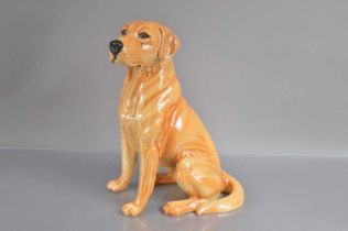 A large 'Fireside' size Beswick model of a seated Golden Labrador Retriever,