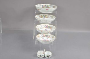 A graduated set of four 20th Century Dresden porcelain reticulated fruits dishes decorated with rose