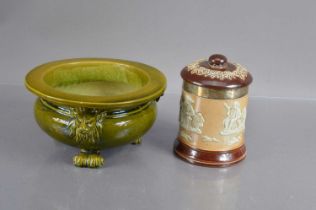 A Bretby green glazed jardinierre or cache pot with lion masks and lion paw feet,