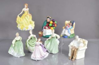 A group of eight Royal Doulton and Wedwood figurines,