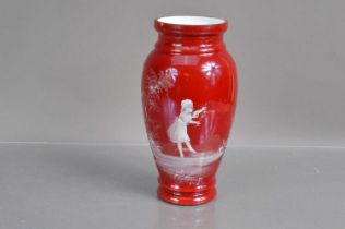 A cased ruby red on white glass 'Mary Gregory' vase,