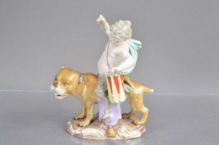 A Meissen porcelain figure group modelled as a young faun with drum riding a lioness.