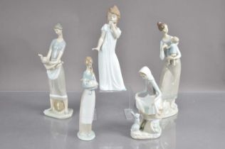 Four Lladro figures and a Nao example,