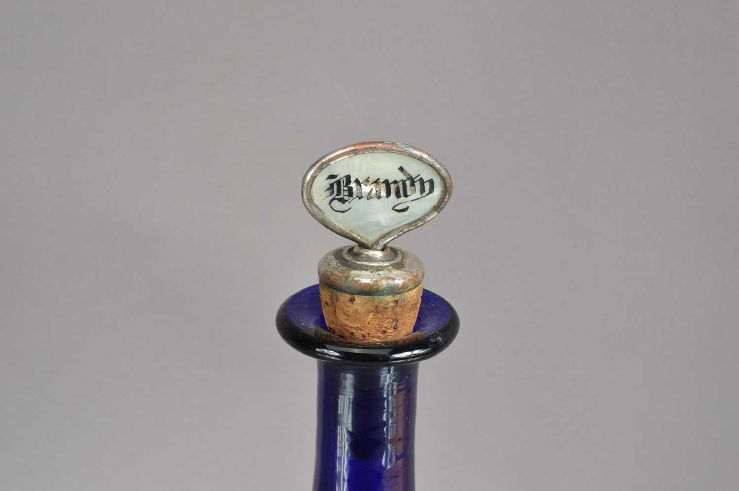 A 'Bristol Blue' glass bottle-shape decanter with silver plated 'Brandy' label stopper, - Image 2 of 4