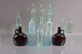 A collection of fifteen antique moulded glass bottles,