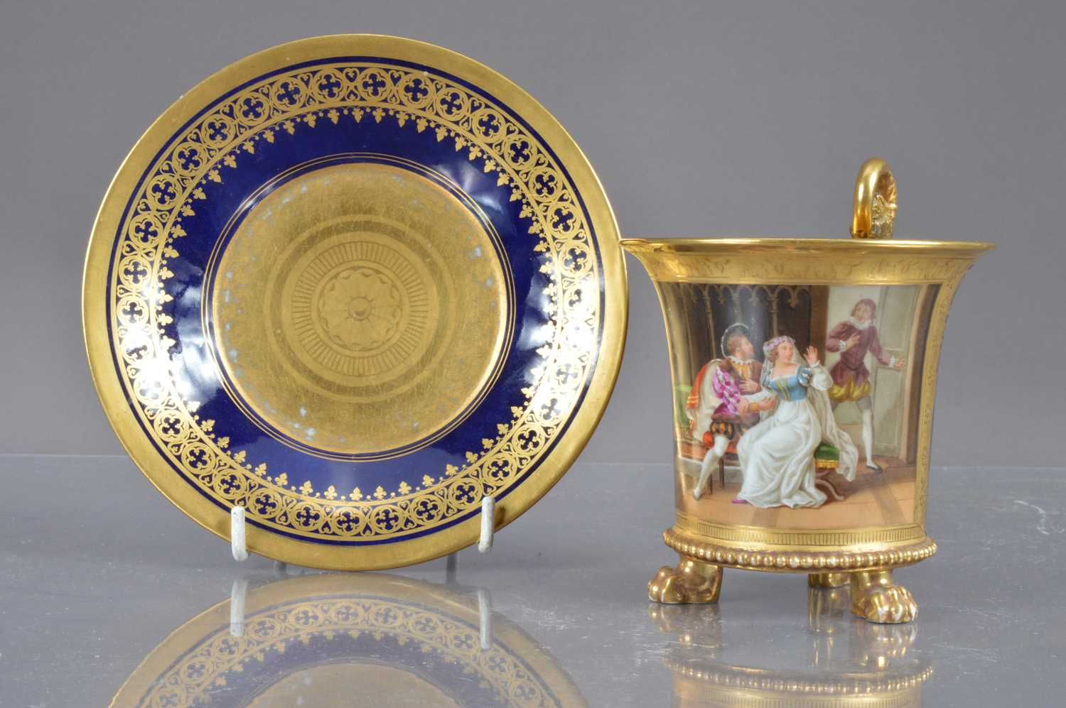 A porcelain chocolate cup and saucer with gilt and enamel decoration,