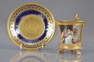 A porcelain chocolate cup and saucer with gilt and enamel decoration,