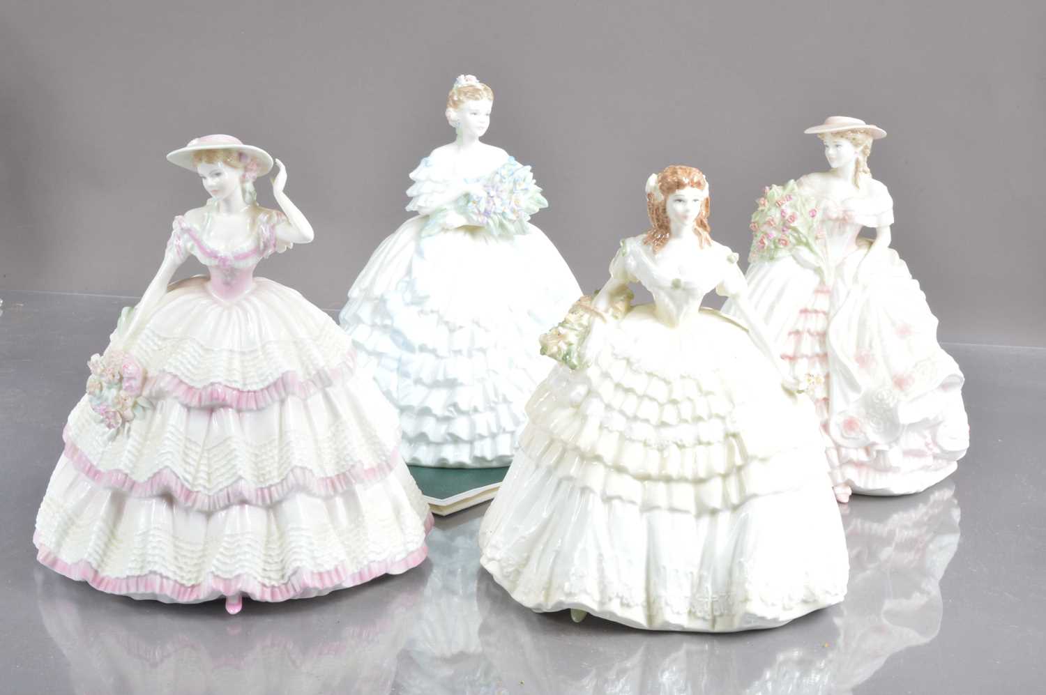 Four Coalport limited edition "Four Flowers" porcelain figurines designed in 1994 by Jack Glynn,