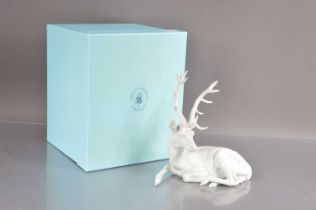 A Nymphenburg white bisque porcelain figure of a resting stag,