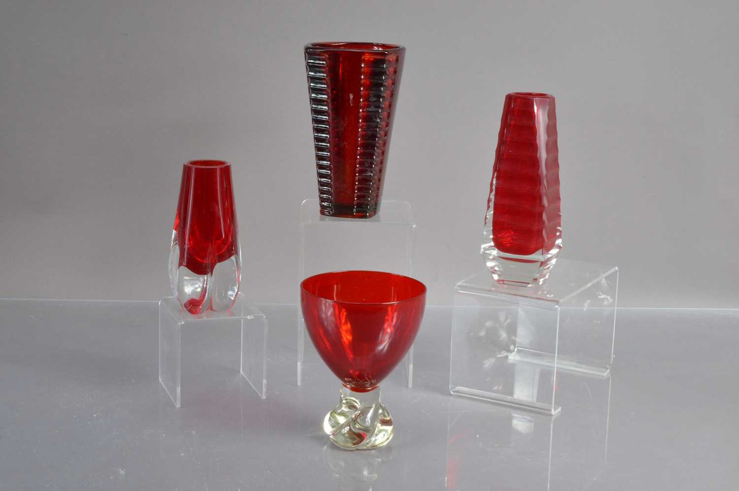 A group of four mid-century modern ruby red art glass items,