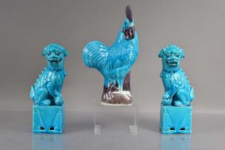 A pair of Chinese turquise glazed moulded posrcelain foo dogs or guardian lions,