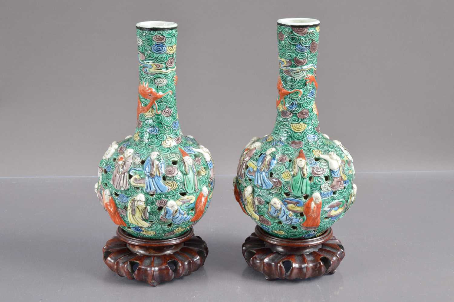 A pair of 19th Century Chinese famille verte relief moulded and reticulated porcelain bottle vases,