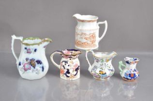 A graduated collection of various graduated jugs,