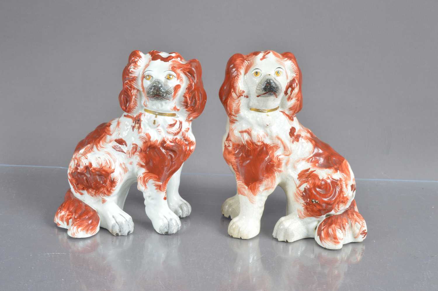 A good pair of small-sized antique Staffordshire pottery spaniel dogs,