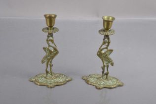 A pair of early 20th Century brass 'Liverbird' candlesticks,