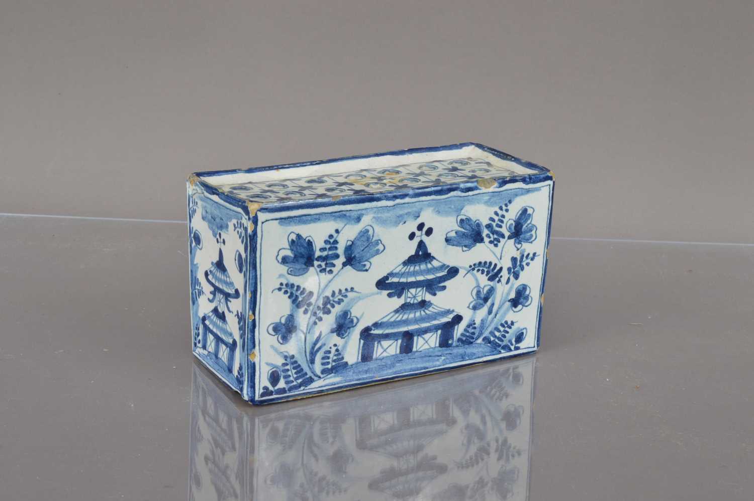 A Delft style blue and white pottery flower brick,