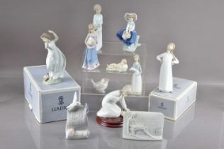 A group of nine Lladro figures and models and two collector's plaques,