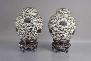 A pair of 19th Century crackle glaze jars and covers,