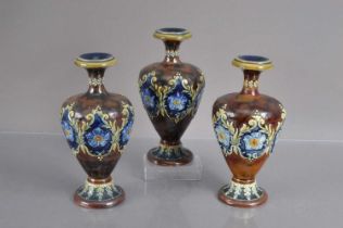 A trio of Doulton Lambeth stoneware vases,