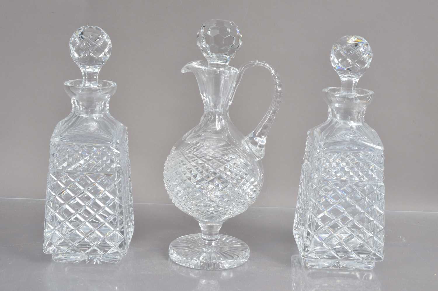 A high quality lead crystal claret jug and a pair of cut crystal whisky or liqueur decanters,