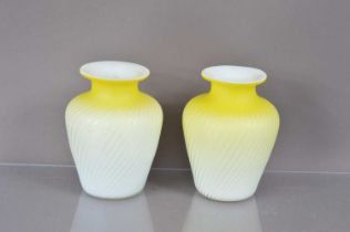 A pair of Victorian canary yellow and white satin glass "Pompeian Swirl" air trap vases,