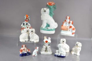 Thirteen various Staffordshire style dogs,